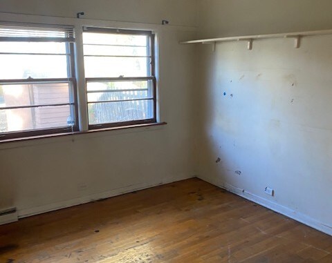 spare room with hardwood / wood-style floors