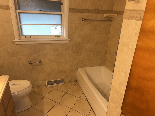 full bathroom featuring tile patterned flooring, vanity, toilet, and tile walls