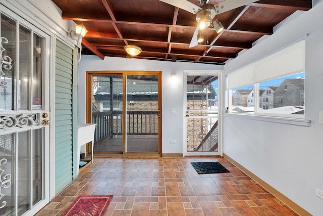 doorway to outside featuring beam ceiling and wooden ceiling