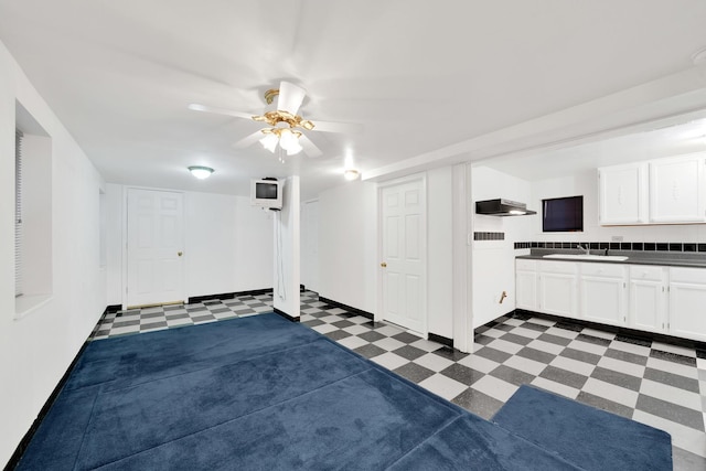 interior space featuring ceiling fan and sink