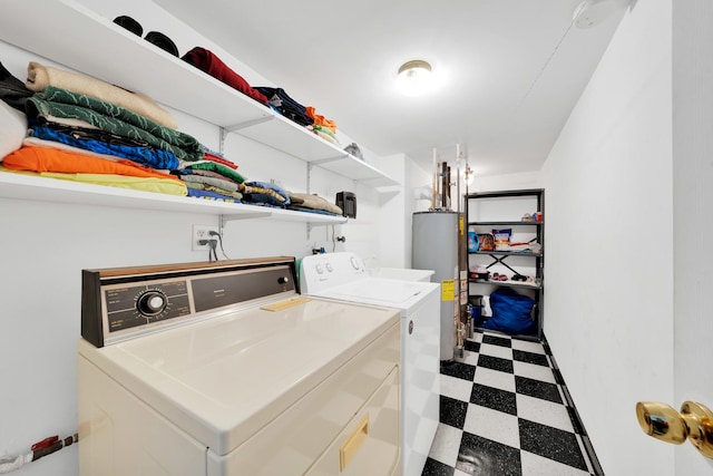 clothes washing area featuring washer and dryer and gas water heater