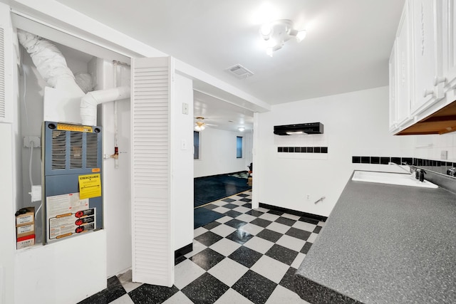 interior space with sink and ceiling fan