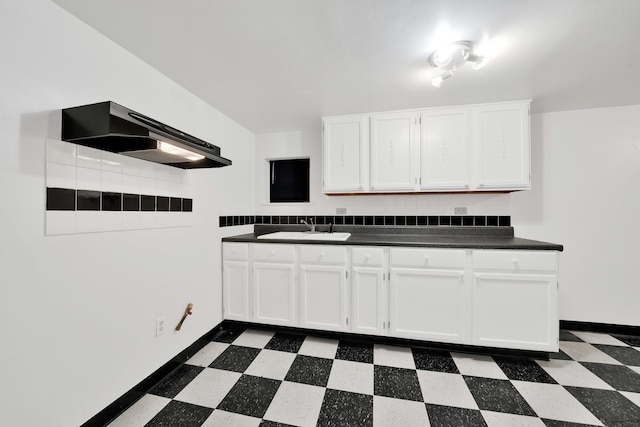 kitchen featuring sink and white cabinets