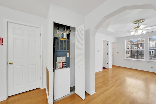 hallway featuring wood-type flooring and heating unit