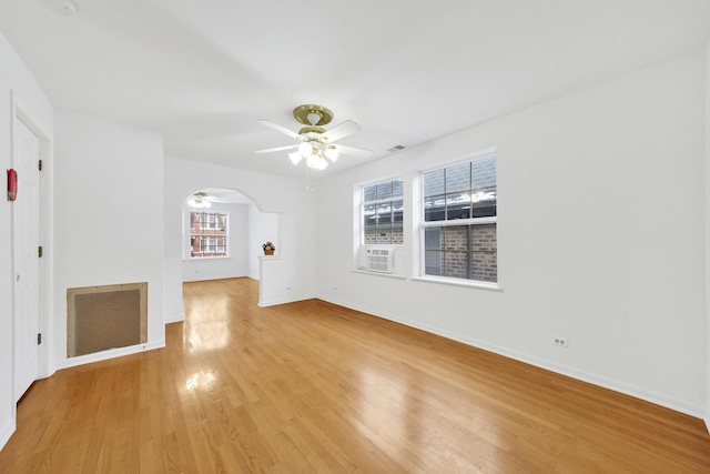 unfurnished living room featuring cooling unit, light hardwood / wood-style floors, and ceiling fan