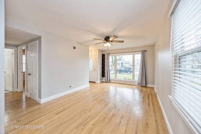 unfurnished room with ceiling fan and light hardwood / wood-style floors