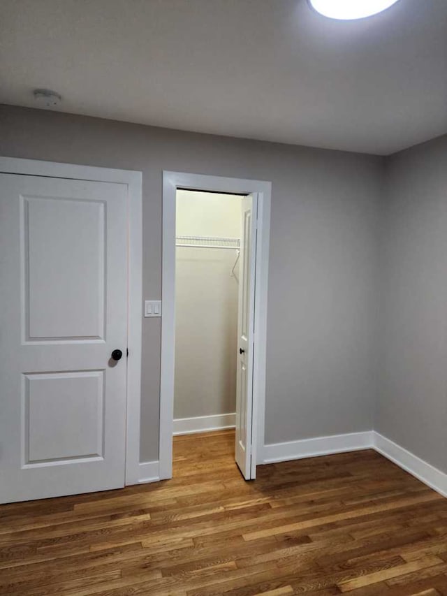 spare room with wood-type flooring