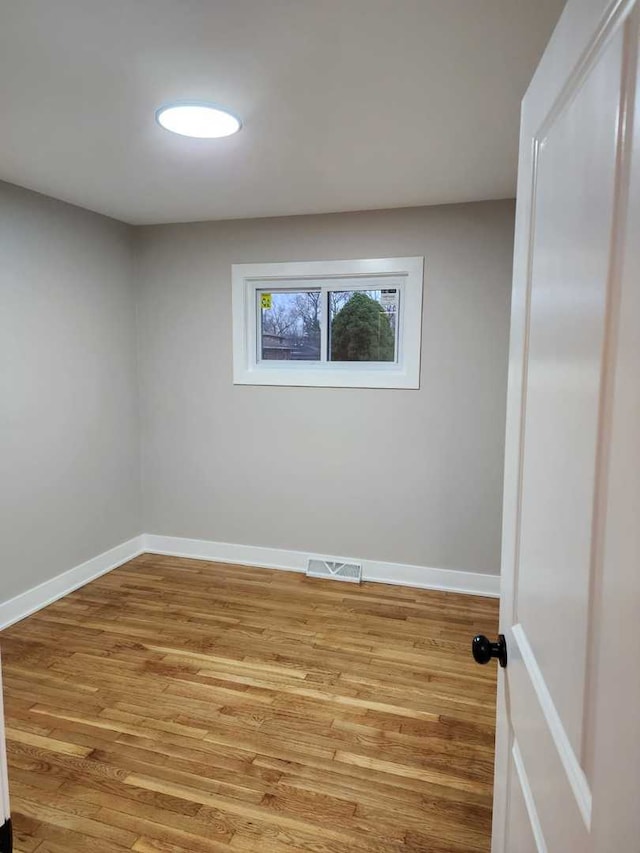 spare room with hardwood / wood-style floors