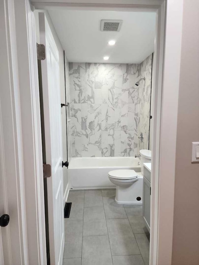 full bathroom featuring tile patterned flooring, vanity, toilet, and tiled shower / bath