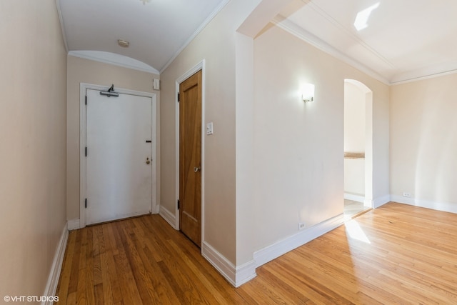 corridor with crown molding and hardwood / wood-style flooring