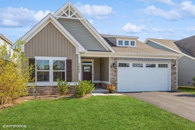 craftsman inspired home featuring a garage and a front yard