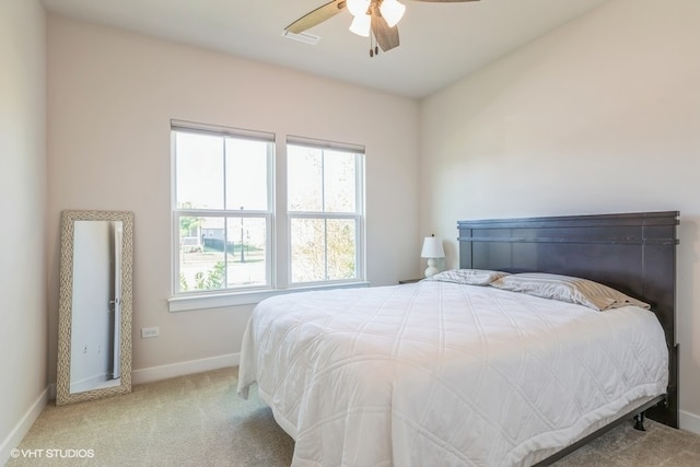 bedroom featuring light carpet and ceiling fan