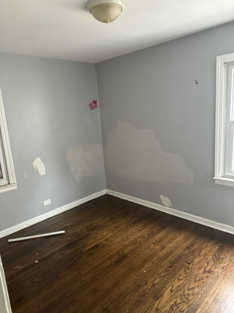 empty room featuring dark hardwood / wood-style flooring