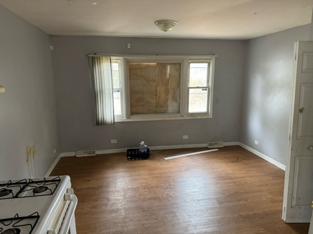 unfurnished room featuring hardwood / wood-style flooring