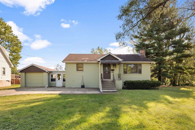 view of front of property with a garage and a front lawn