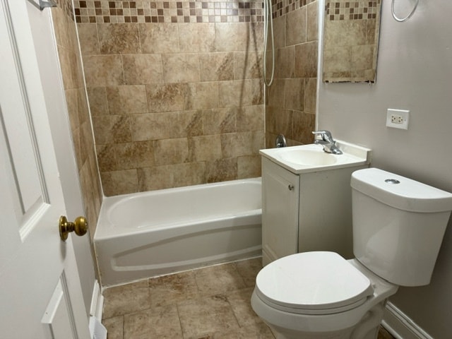 full bathroom featuring vanity, toilet, and tiled shower / bath combo