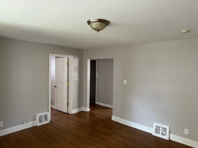 spare room featuring dark hardwood / wood-style floors