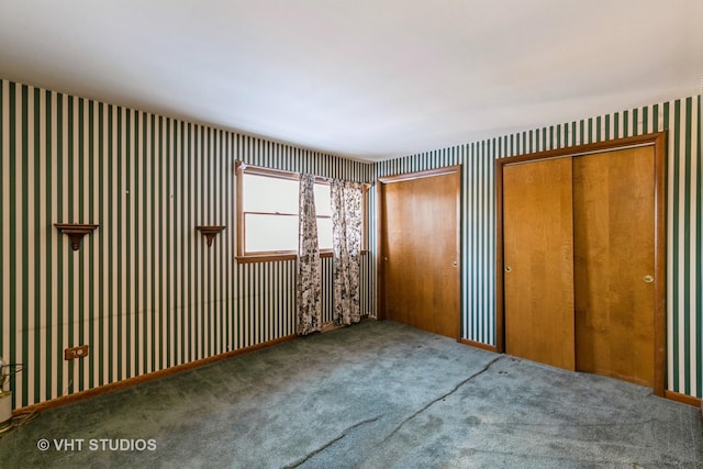 unfurnished bedroom featuring carpet and multiple closets