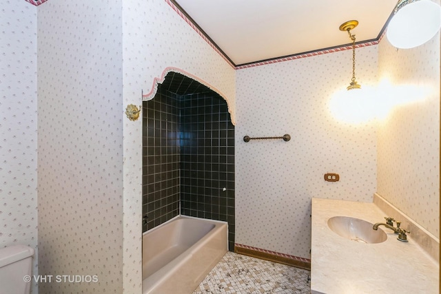 full bathroom with toilet, tile patterned flooring, tiled shower / bath combo, and vanity