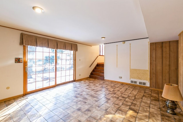 empty room featuring wooden walls