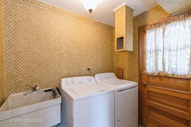 washroom featuring washer and dryer and sink