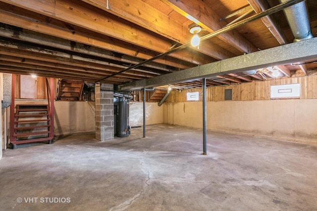 basement featuring water heater and plenty of natural light