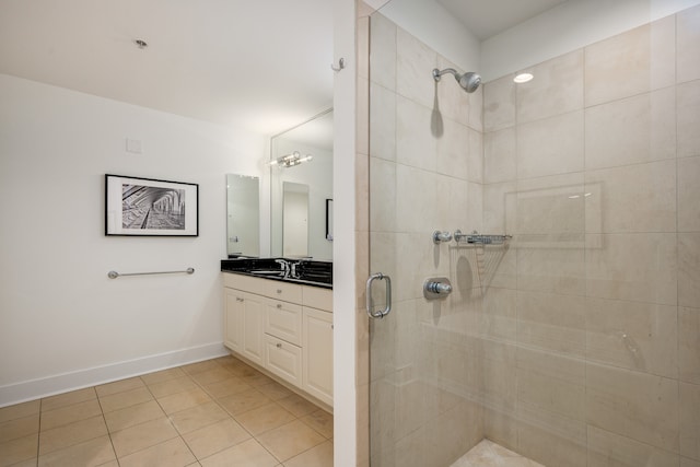 bathroom with tile patterned flooring, walk in shower, and vanity