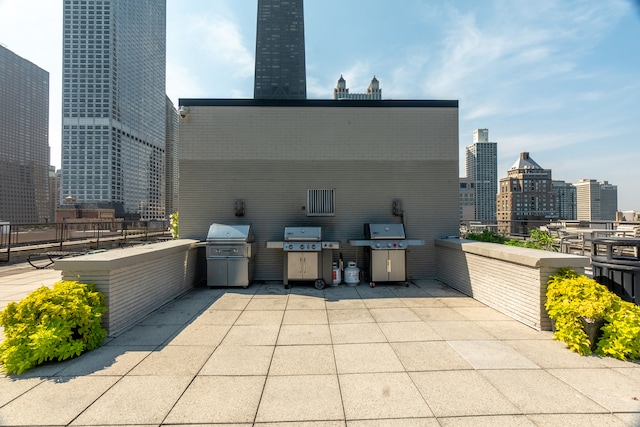 view of patio / terrace featuring exterior kitchen and a grill