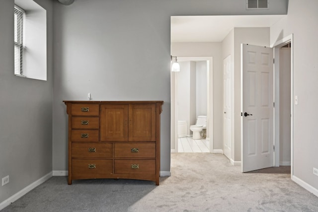 carpeted bedroom with ensuite bath