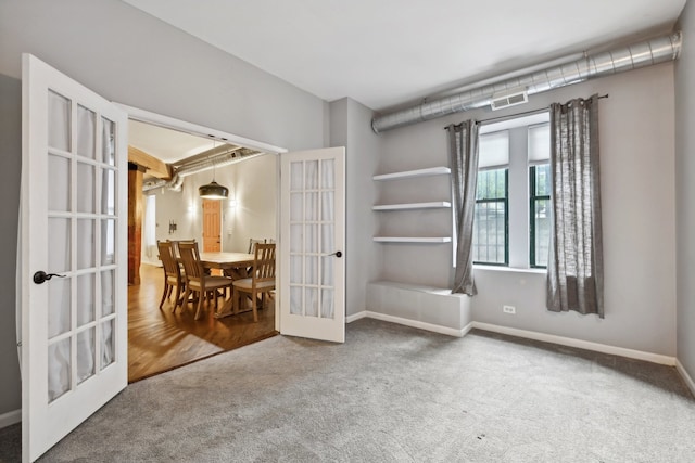 carpeted spare room with french doors