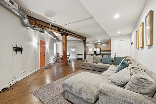 living room with hardwood / wood-style flooring and decorative columns