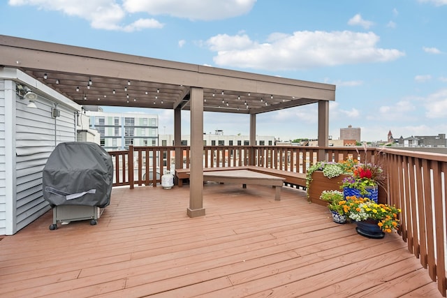 wooden terrace with a pergola and grilling area