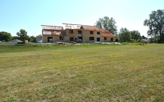 rear view of property with a yard