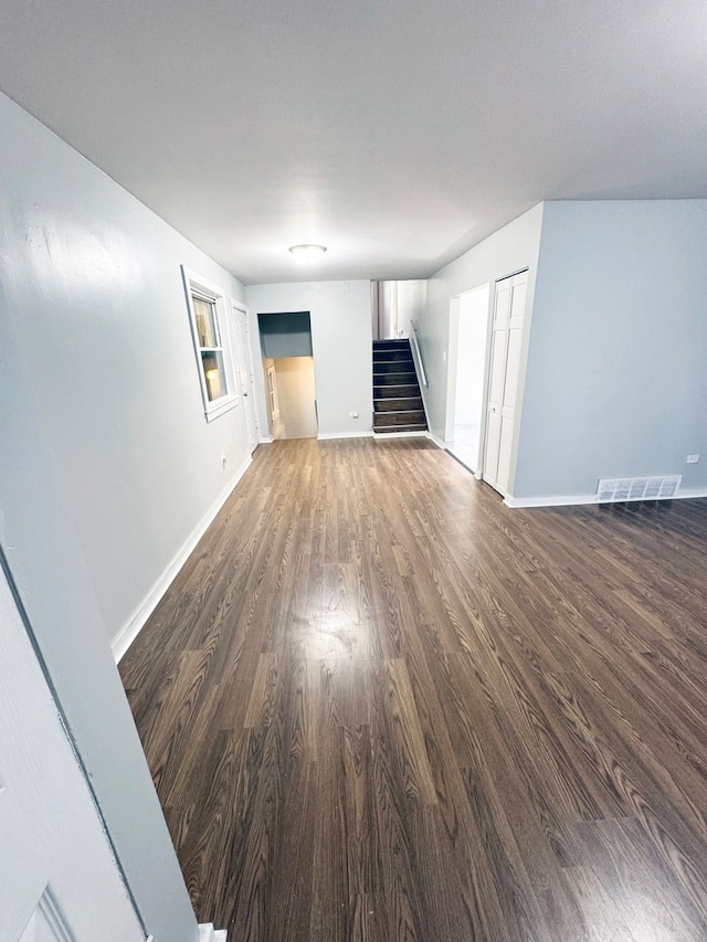 unfurnished living room with dark hardwood / wood-style flooring