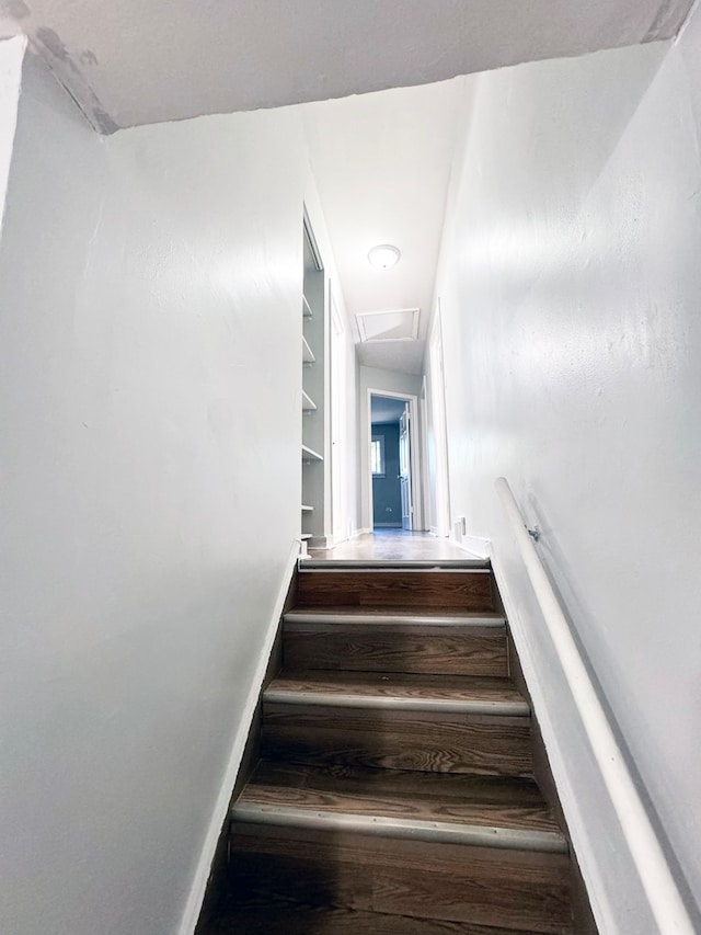 staircase with hardwood / wood-style floors