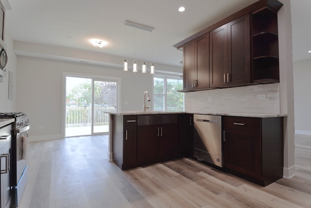 kitchen with kitchen peninsula, hanging light fixtures, light hardwood / wood-style flooring, stainless steel appliances, and dark brown cabinetry