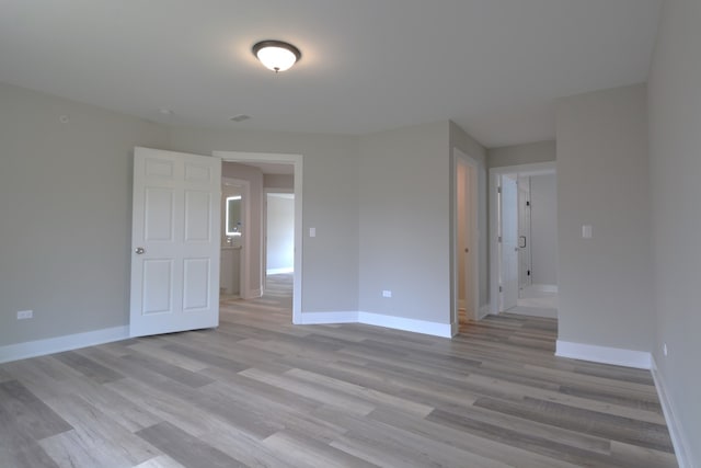 empty room with light hardwood / wood-style flooring