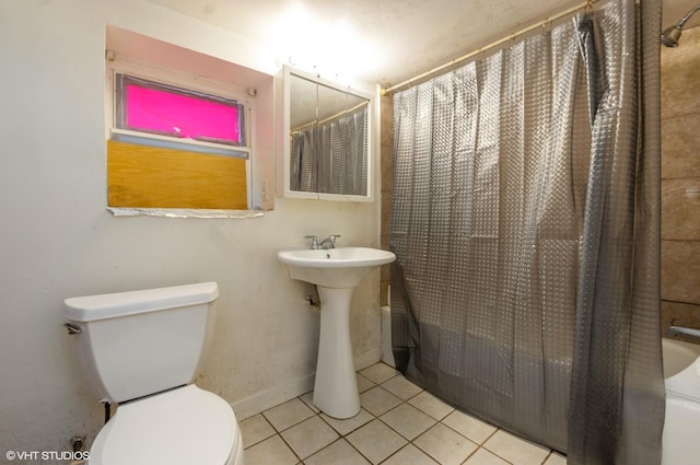 bathroom featuring tile patterned floors, shower / bath combo, and toilet