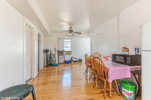 dining area with ceiling fan and light wood-type flooring