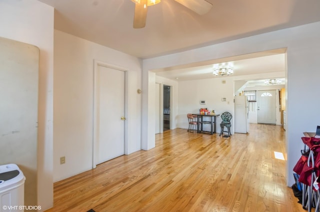 living area with light wood-style floors and a ceiling fan