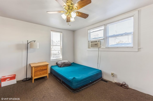 bedroom with dark carpet and a ceiling fan