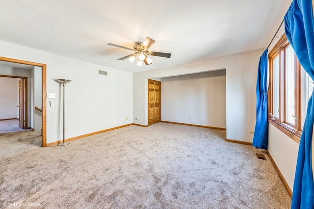 unfurnished bedroom featuring ceiling fan and carpet