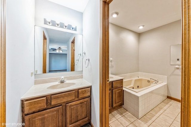 bathroom featuring tile patterned flooring, a relaxing tiled tub, and vanity