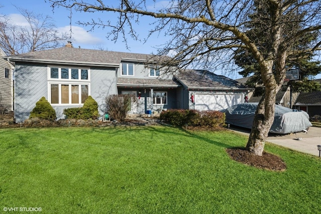 view of front of home with a front yard and a garage