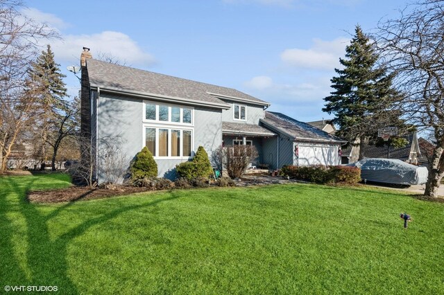 5042 Boulders Dr, Gurnee, IL 60031 - view of front of home featuring a chimney, a front lawn, and stucco siding