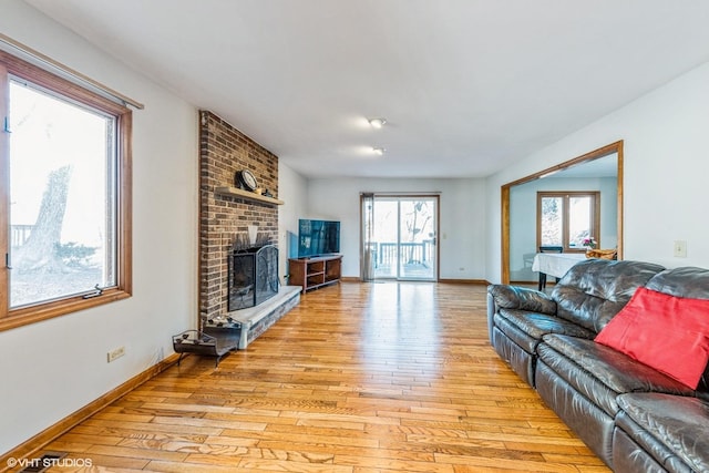 5042 Boulders Dr, Gurnee, IL 60031 - living area featuring light wood-type flooring, a fireplace, and baseboards