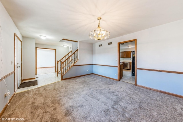 5042 Boulders Dr, Gurnee, IL 60031 - spare room featuring a chandelier, stairway, carpet floors, and baseboards