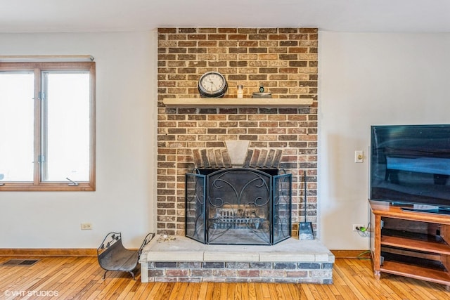 interior details featuring hardwood / wood-style floors and a fireplace