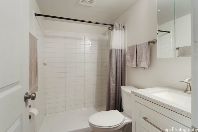 bathroom featuring vanity, toilet, and walk in shower