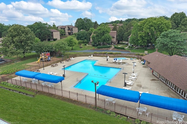 view of pool featuring a lawn and a patio area